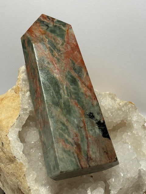 Green emerald point with bixbite (red emerald) inclusions