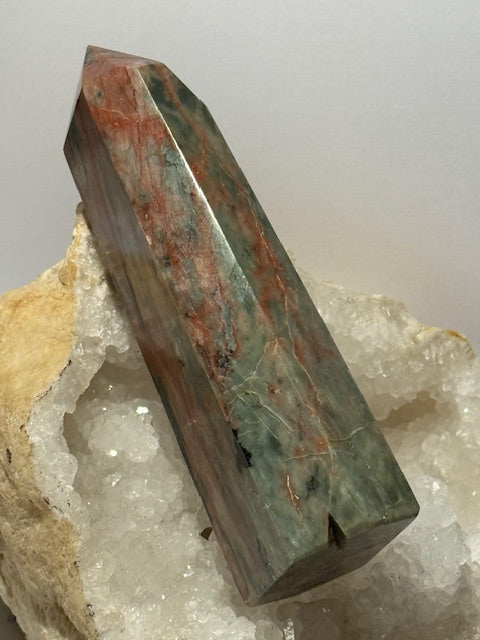 Green emerald point with bixbite (red emerald) inclusions