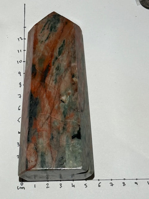 Green emerald point with bixbite (red emerald) inclusions