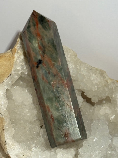 Green emerald point with bixbite (red emerald) inclusions