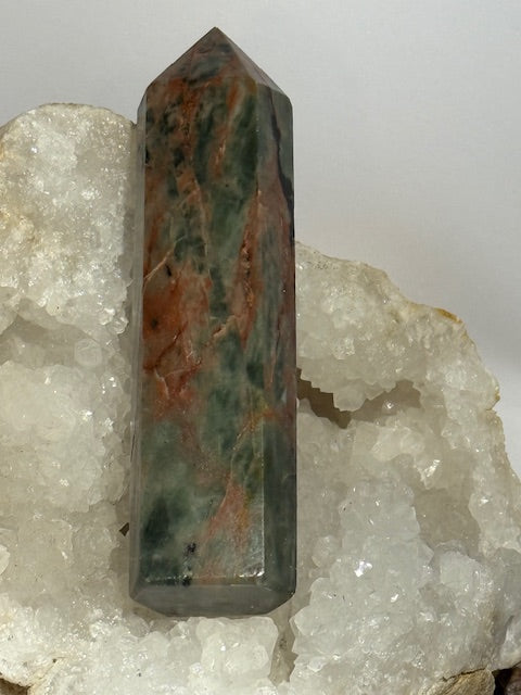 Green emerald point with bixbite (red emerald) inclusions