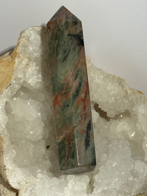 Green emerald point with bixbite (red emerald) inclusions