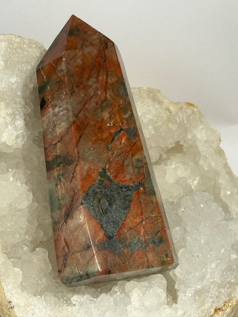 Green emerald point with bixbite (red emerald) inclusions