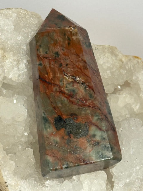 Green emerald point with bixbite (red emerald) inclusions
