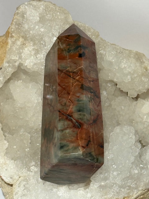 Green emerald point with bixbite (red emerald) inclusions