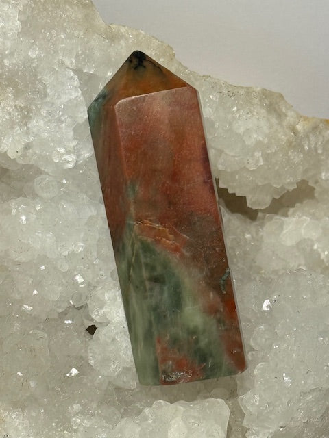 Green emerald point with bixbite (red emerald) inclusions