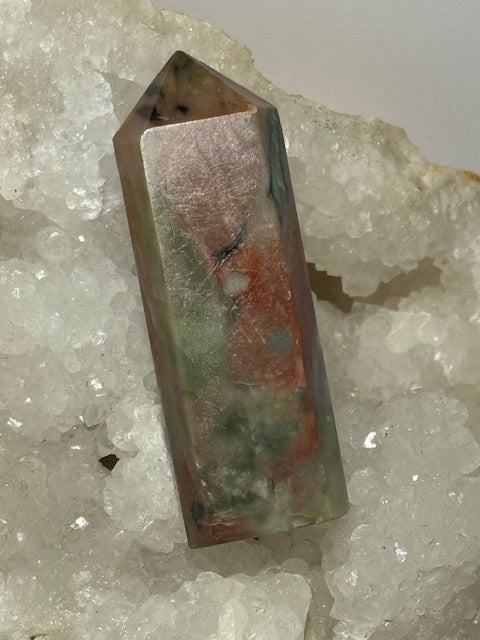 Green emerald point with bixbite (red emerald) inclusions