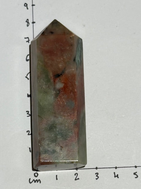 Green emerald point with bixbite (red emerald) inclusions