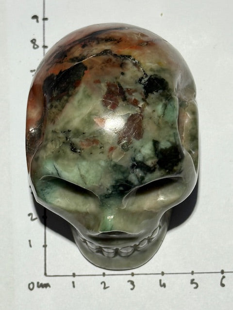 Green emerald skull with bixbite (red emerald) inclusions